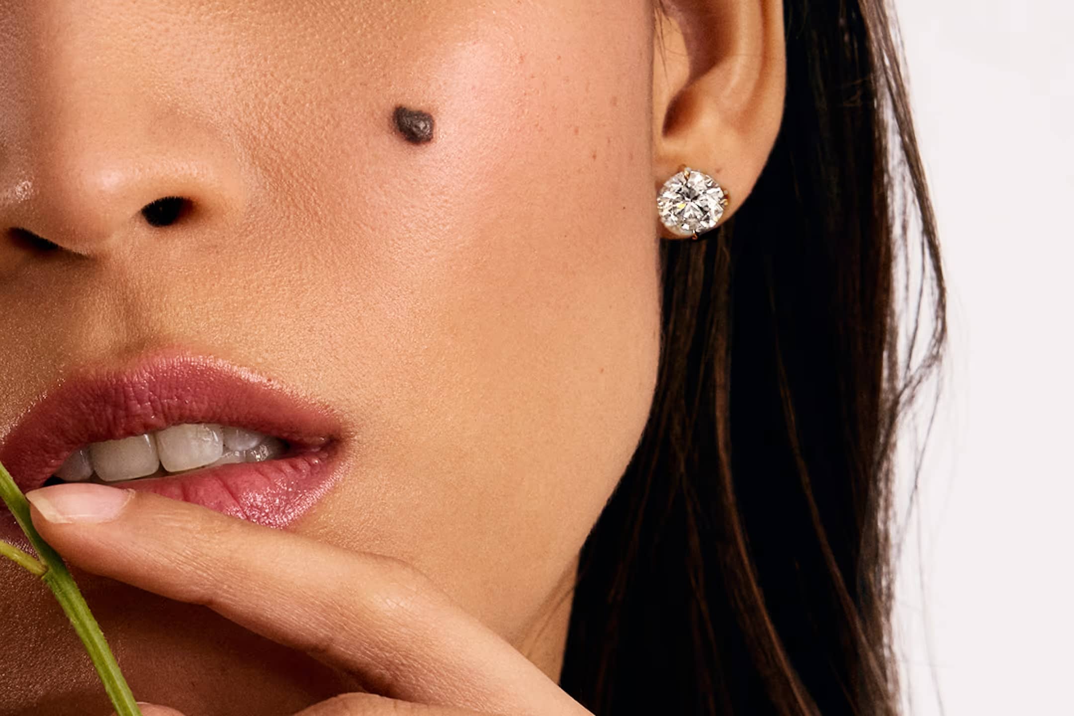 Diamond Studs showcase featuring a lifestyle image of an engagement ring, highlighting the collection's signature distinctive design elements against an elegant background