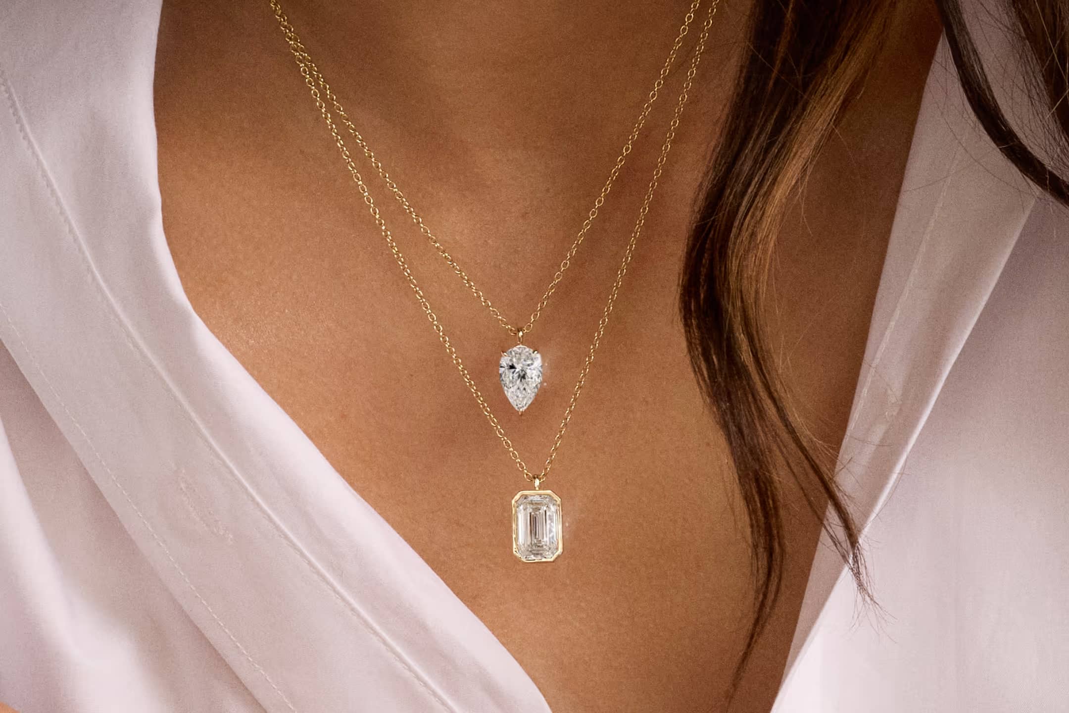 Diamond Pendants showcase featuring a lifestyle image of an engagement ring, highlighting the collection's signature distinctive design elements against an elegant background