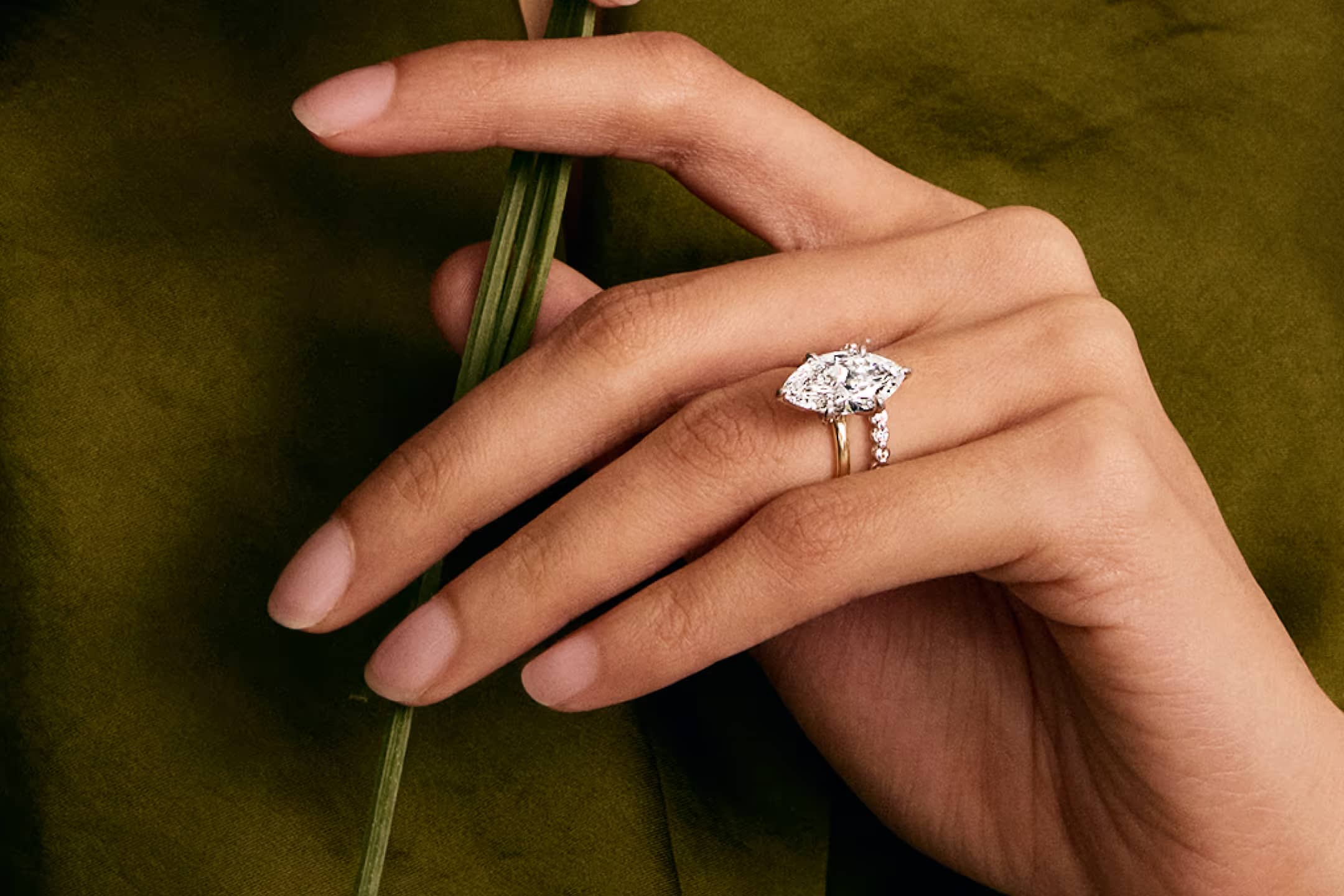 The Royale Collection showcase featuring a lifestyle image of an engagement ring, highlighting the collection's signature royale engagement ring with regal craftsmanship against an elegant background