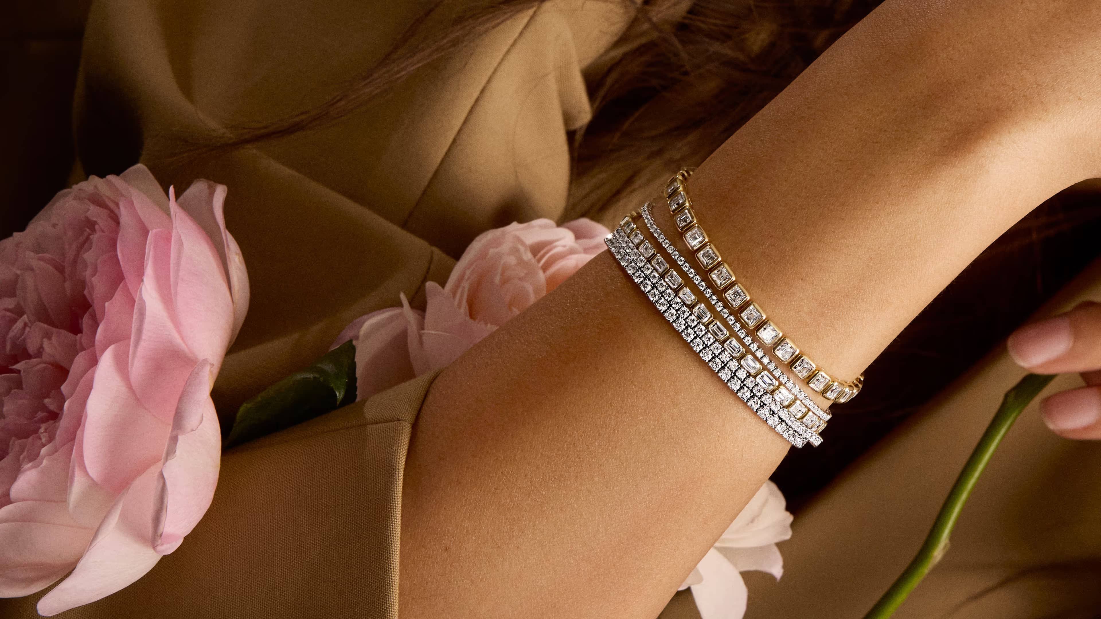 Tennis Bracelets showcase featuring a lifestyle image of an engagement ring, highlighting the collection's signature distinctive design elements against an elegant background