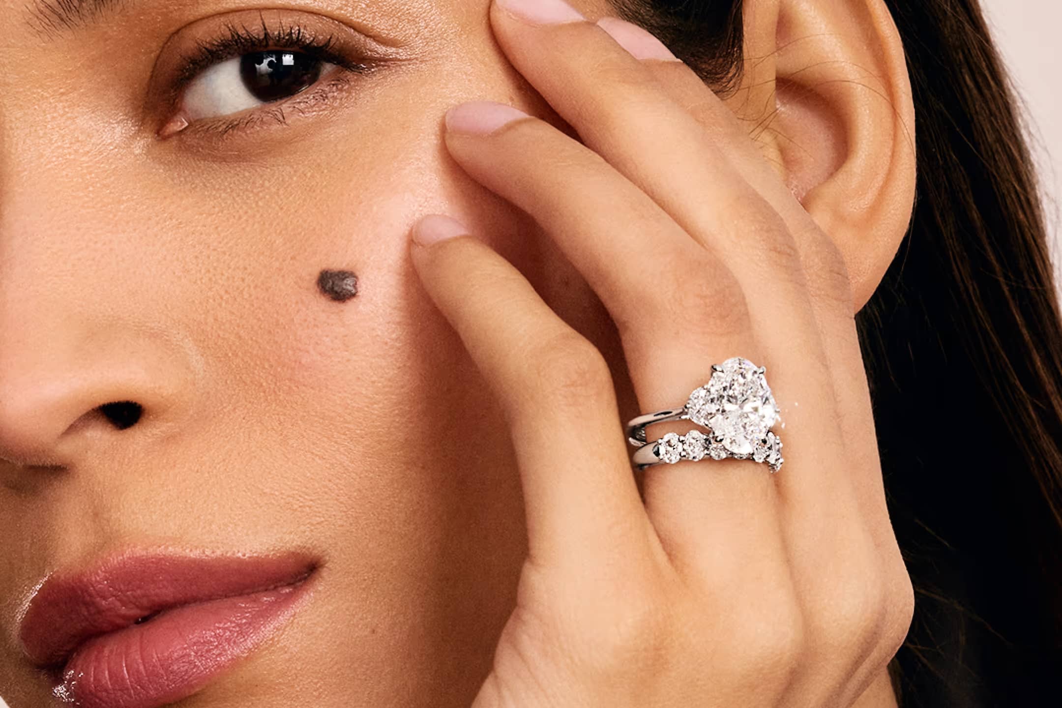 The Nouveau Collection showcase featuring a lifestyle image of an engagement ring, highlighting the collection's signature unique nouveau setting against an elegant background