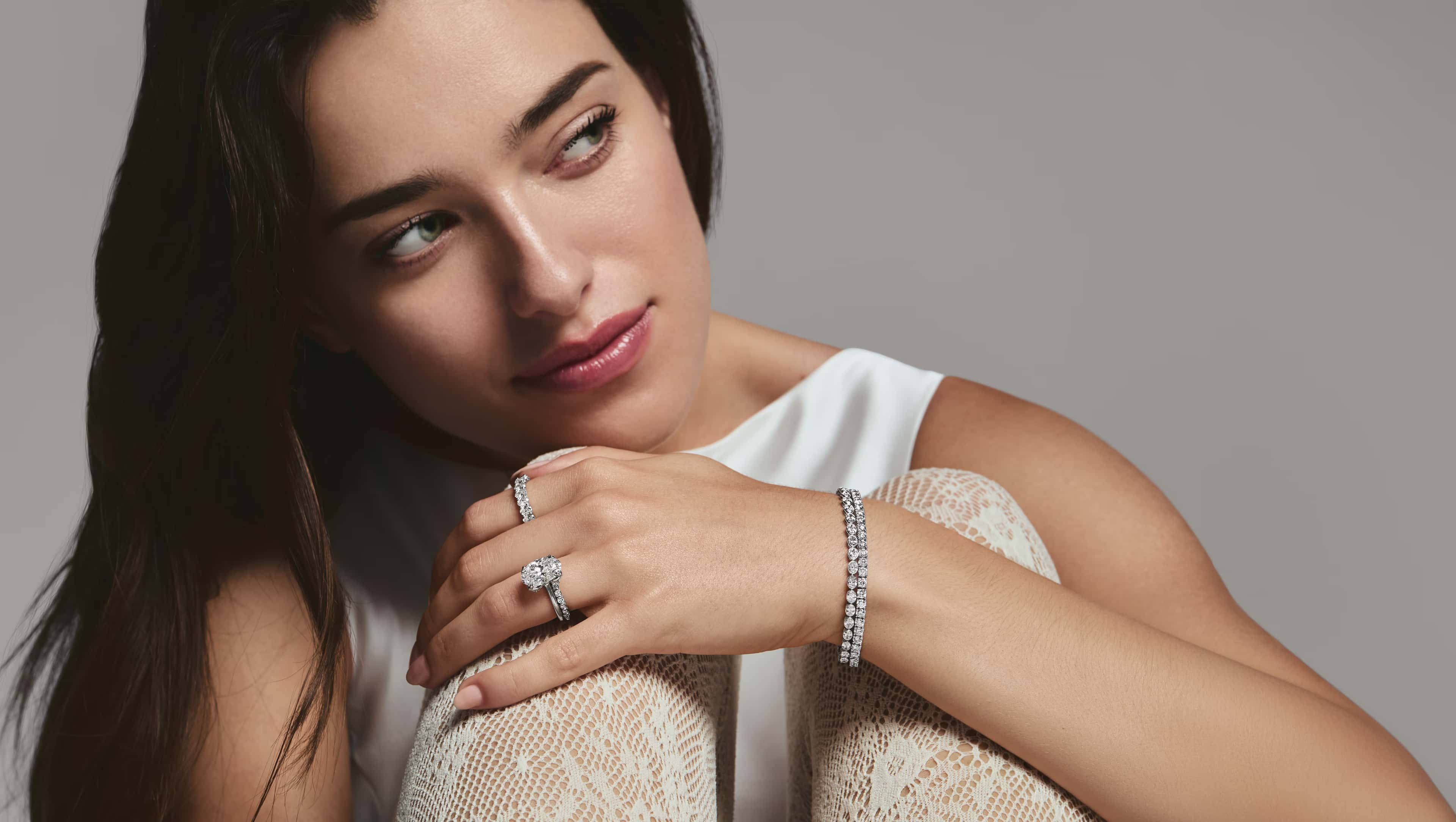 A close-up of an engagement ring with text overlay reading 'Find the Perfect Ring, Make it yours' against a dark background